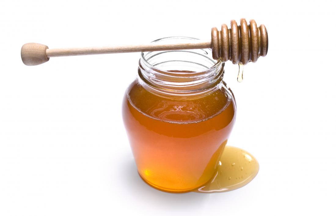 honey-has-been-consumed-for-thousands-of-years-for-its-supposed-health-benefits-jar-of-honey-with-wooden-dipper-on-top-dripping-honey